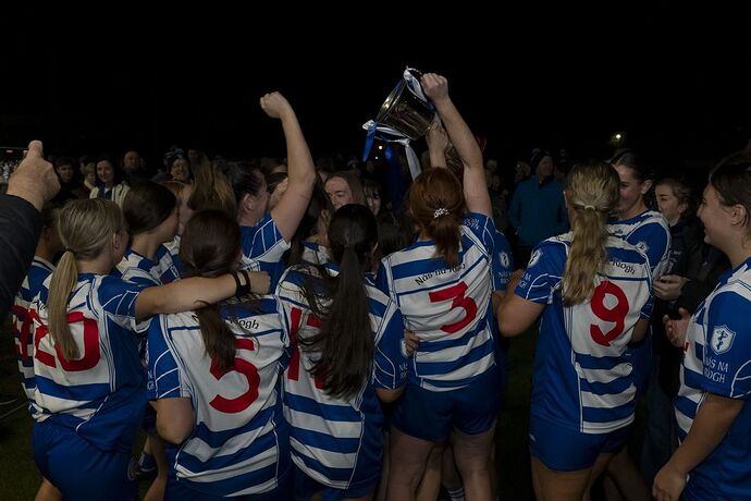 Victorious Naas Camogie players celebrate with the trophy on the pitch at Cedral St Conleth's Park, Newbridge, Co Kildare. October 10, 2025. Image: Aisling Hyland Photography