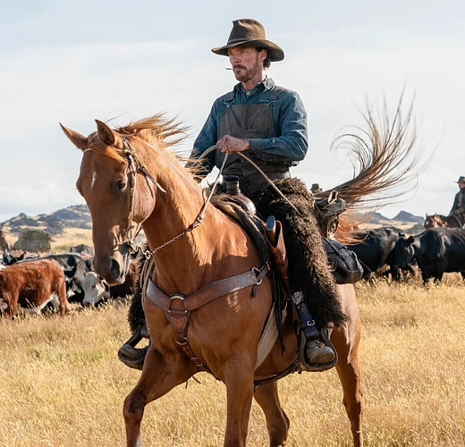 Benedict Cumberbatch and Jesse Plemons on horseback in a scene from "The Power of the Dog."