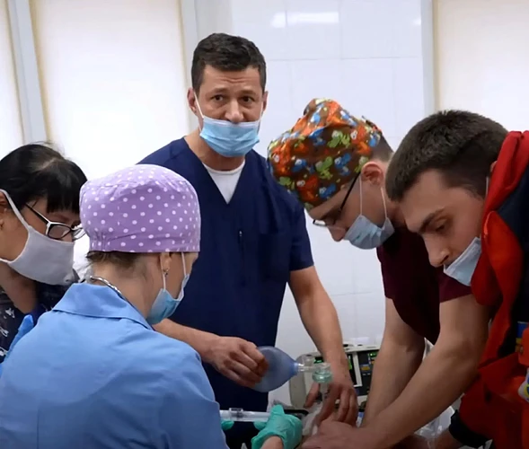Medical personnel attending to a patient in an emergency room.